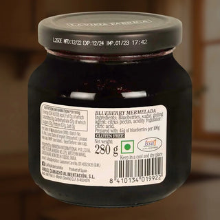 Jar of blueberry marmalade with a visible label on a brown background