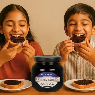 Two children enjoying toast with blueberry spread and a jar of La Vieja Fábrica blueberry spread in the foreground.