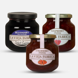 Three jars of La Vieja Fábrika Jams blueberries, raspberries, and strawberries  on a white background