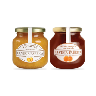 Two jars of La Vieja F&aacute;brica marmalade, one pineapple and one Seville orange, on a white background.